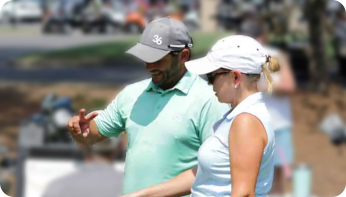 Coach coaching a golfer