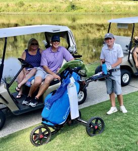 Family watching their son playing golf in an Op 36 9-hole event