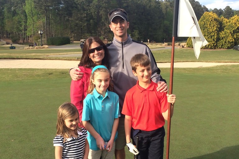 Family of 5 golfing together