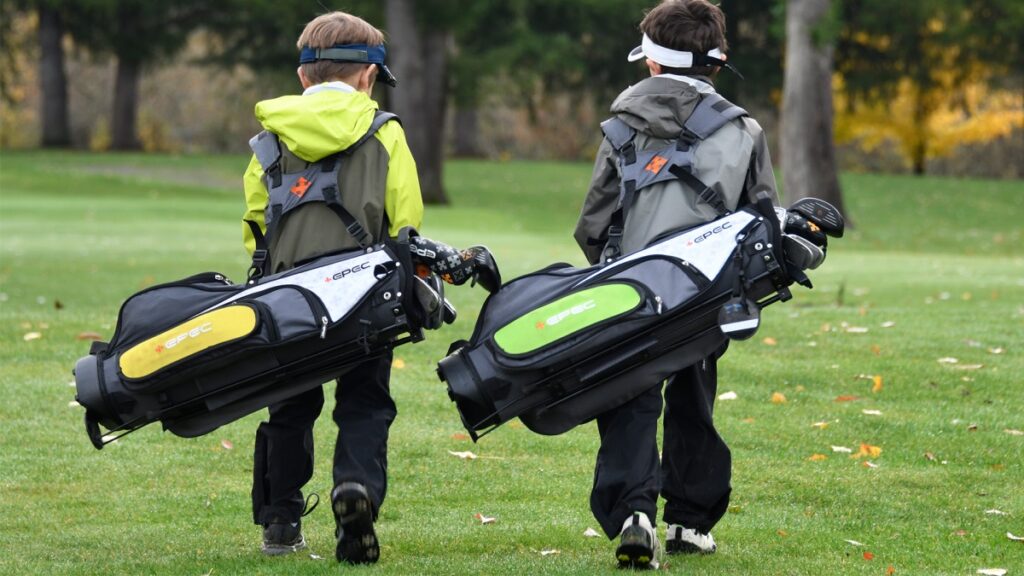 Junior golfers carrying their Epec golf clubs