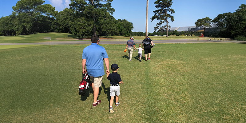 Junior golfers celebrating on course during a 9-Hole Event Play Day