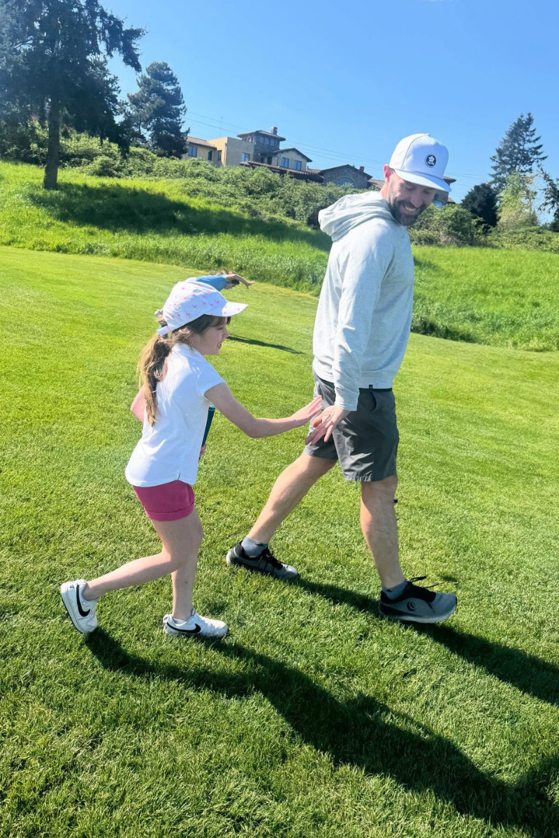 Junior golfer with coach on the practice area